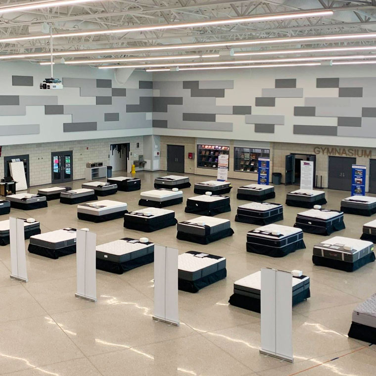 A bunch of mattresses at a school gym